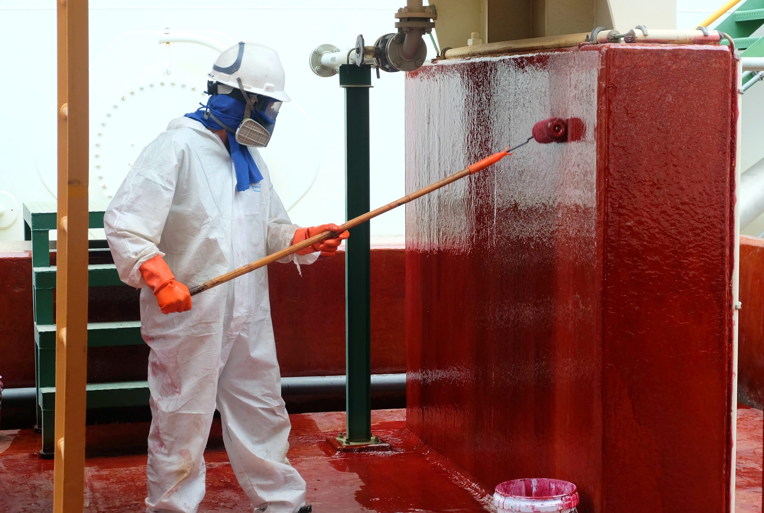 A worker in protective gear doing transocean coatings